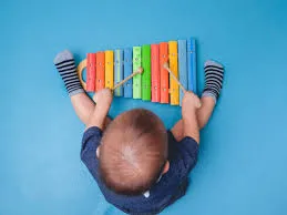Child playing with a xylophone