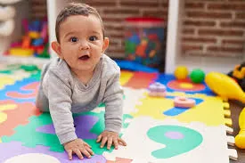 Baby crawling on a mat