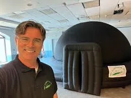Man with a blow up planetarium