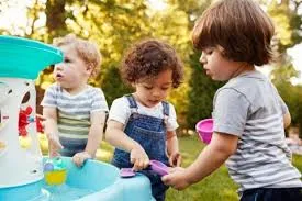 Toddlers playing with a watertable
