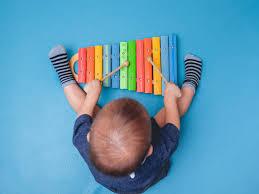 Child playing with a xylophone